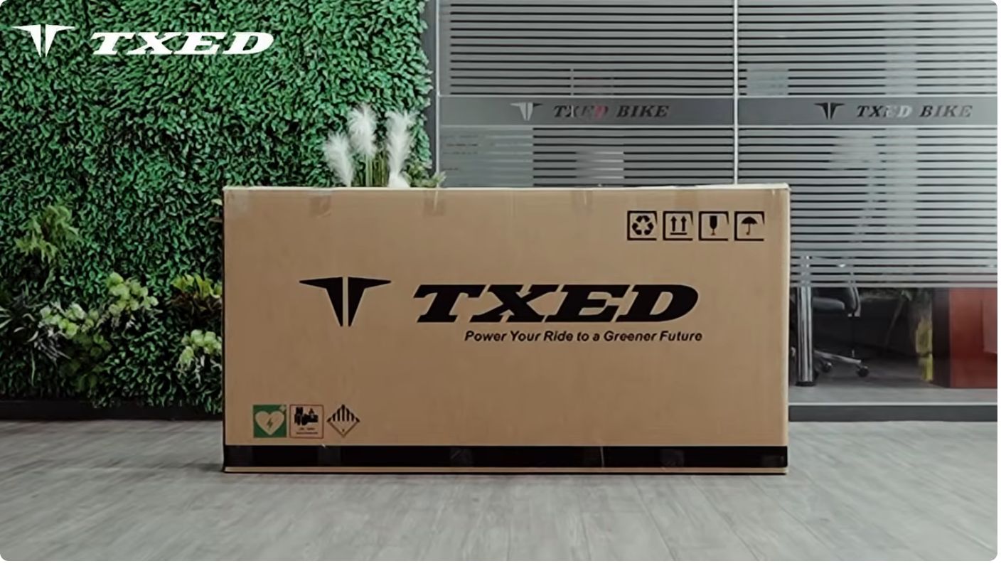 Trail 27.5” Electric Bike – Orange in its TXED shipping box